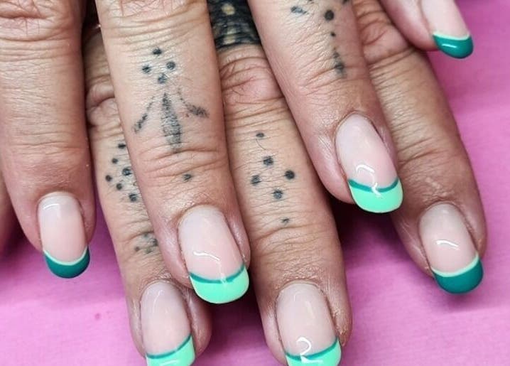 Vibrant green French manicure at The Polish Room in Taupō, Waikato, NZ on display against a pink backdrop.