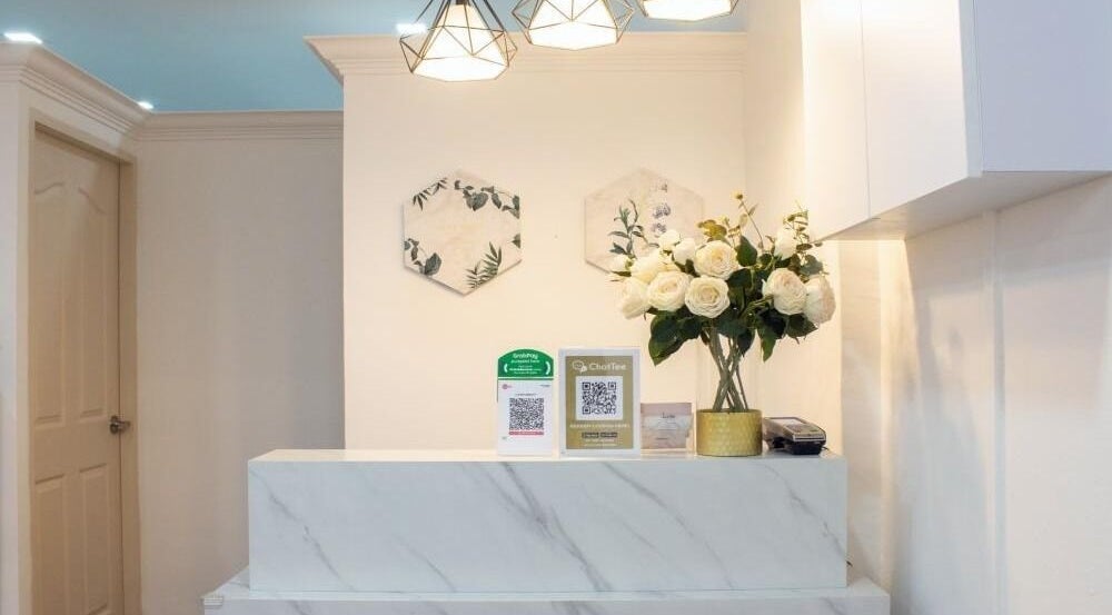Reception area at Lavish Beauty, Singapore, Singapore, SG with floral decor and marble counter.
