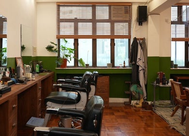 Interior of Goodman Barber Shop in Causeway Bay, Hong Kong Island, HK with classic decor and barber chairs.