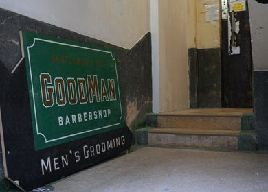 Entrance of Goodman Barber Shop in Causeway Bay, Hong Kong Island, featuring a vintage sign for men's grooming.
