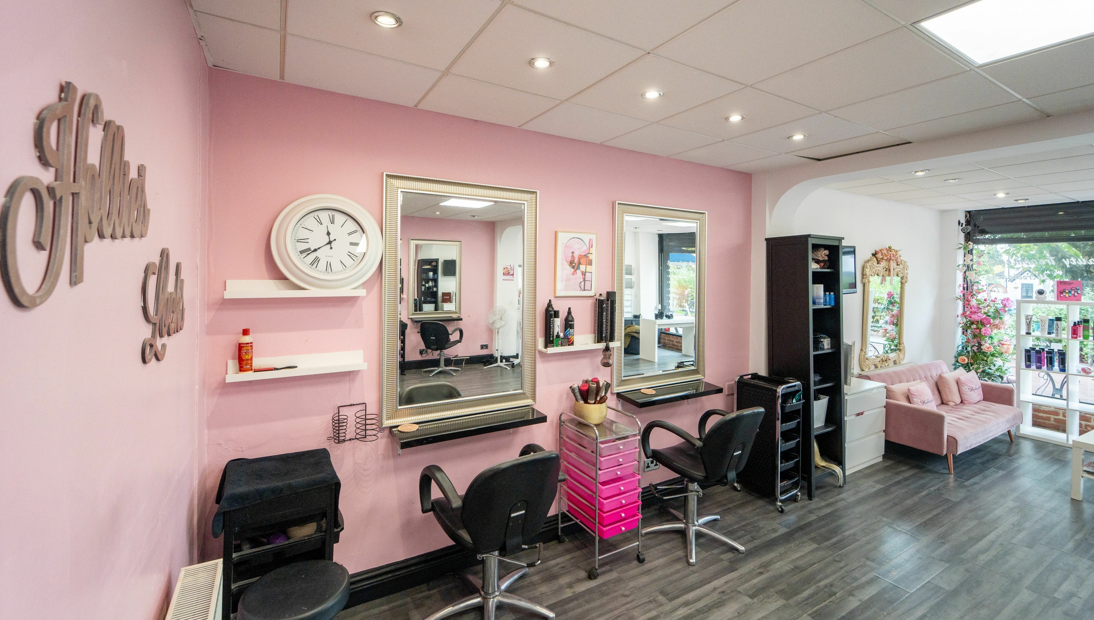 Hollieslocks Salon in Hornchurch, England, GB, featuring stylish pink decor and elegant mirrors.