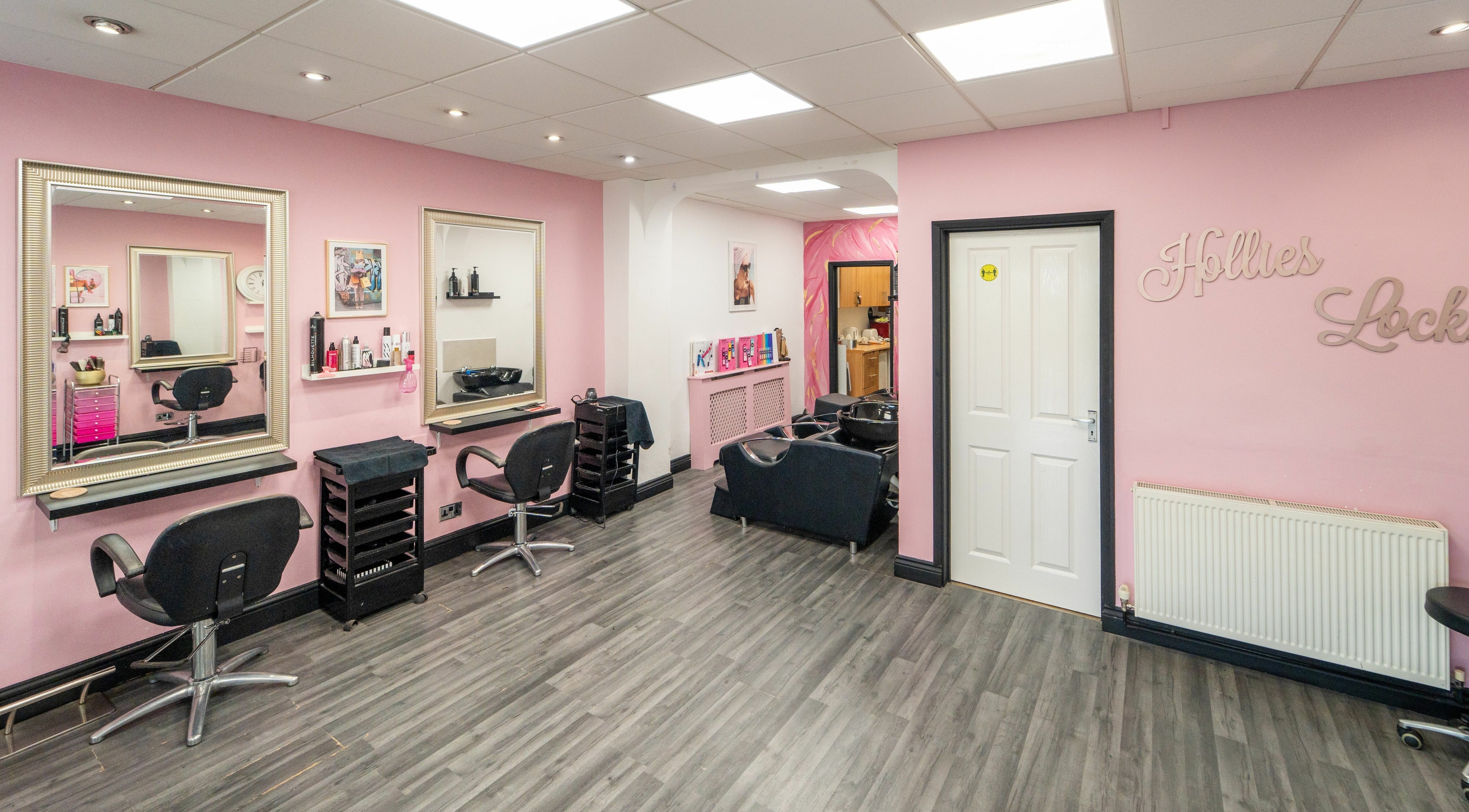 Modern interior of Hollieslocks Salon in Hornchurch, England, GB with stylish chairs and mirrors.