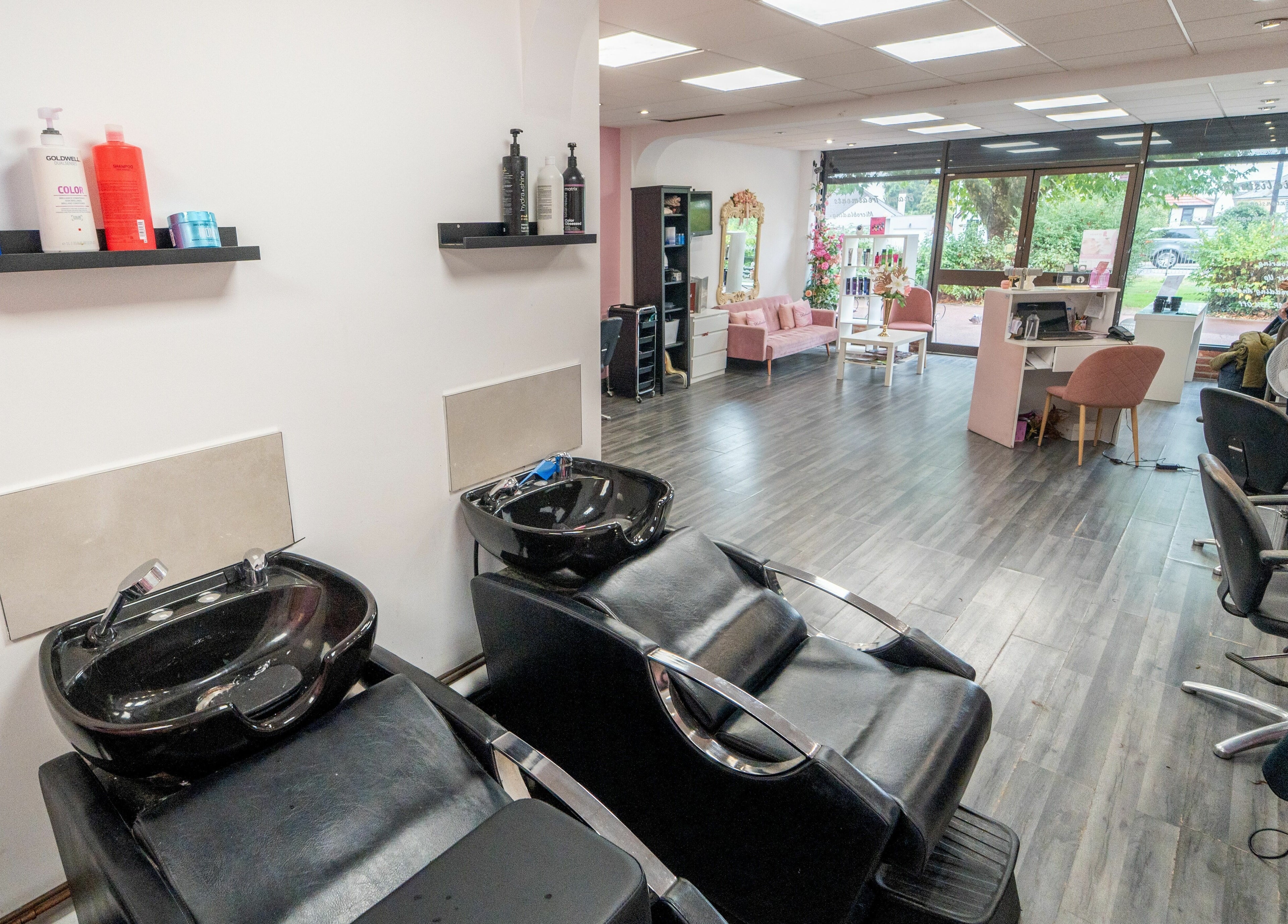 Modern interior of Hollieslocks Salon in Hornchurch, England, GB with sleek design and styling stations.
