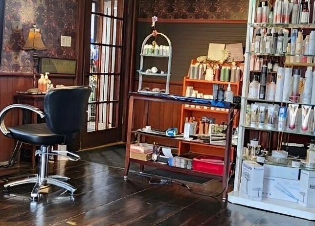 Cozy interior of Steampunk'd Salon and Gallery in Yarmouth, Nova Scotia, CA with stylish seating and products.