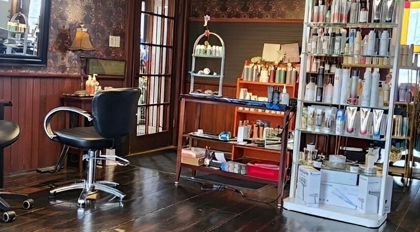 Cozy interior of Steampunk'd Salon and Gallery in Yarmouth, Nova Scotia, CA with stylish seating and products.