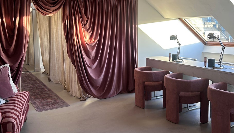 Luxurious interior of Emily Marietta Barker, Glasgow, Scotland, GB, featuring velvet drapes and modern seating.