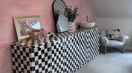 Chic decor at Emily Marietta Barker, Glasgow, Scotland, GB, with checkered cabinet and pink walls.
