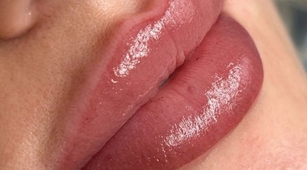 Glossy pink lips showcasing lip treatment at Emily Marietta Barker, Glasgow, Scotland, GB.
