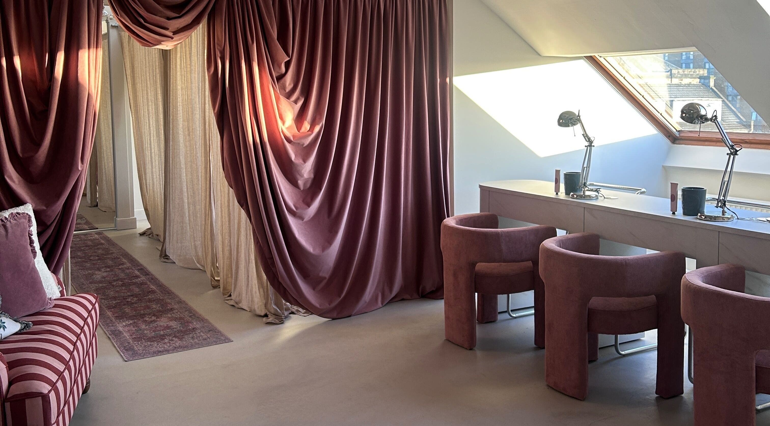 Luxurious interior of Emily Marietta Barker in Glasgow, Scotland, GB with plush chairs and velvet drapes.
