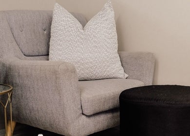 Relaxing grey chair with decor at Base Coat Melkbos, Cape Town, Western Cape, ZA.