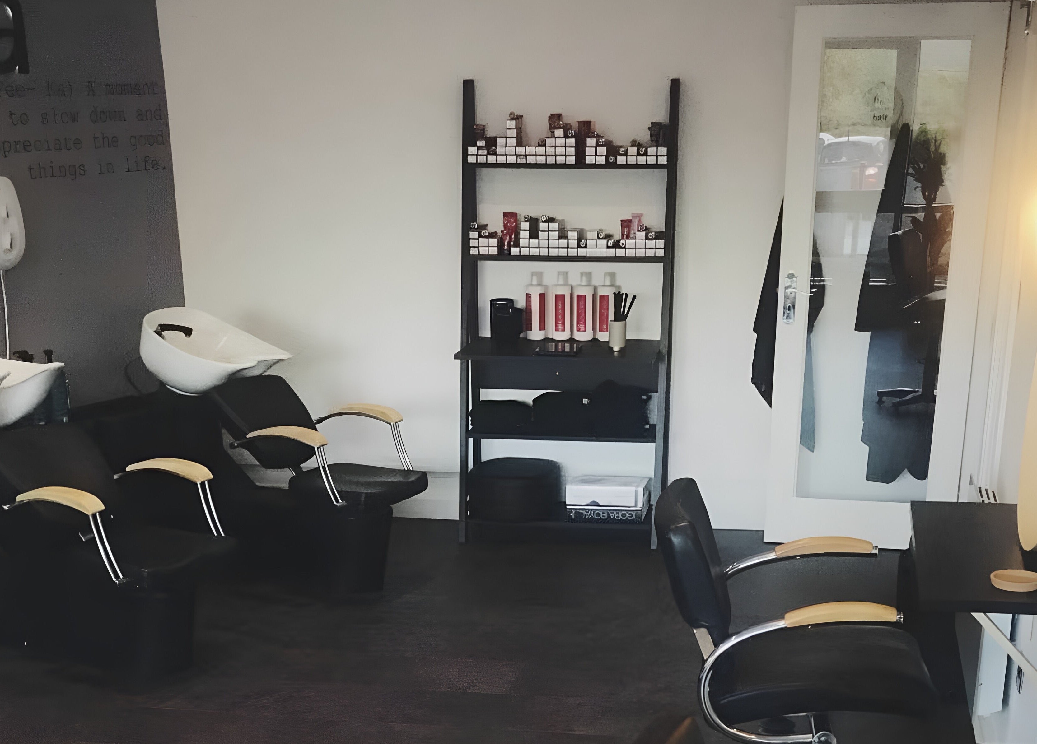 Modern wash station at Fika Hair - Caton Road, Lancaster, England, GB with stylish chairs and product display.