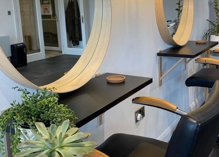 Elegant salon setup with large round mirrors at Fika Hair - Caton Road, Lancaster, England, GB.