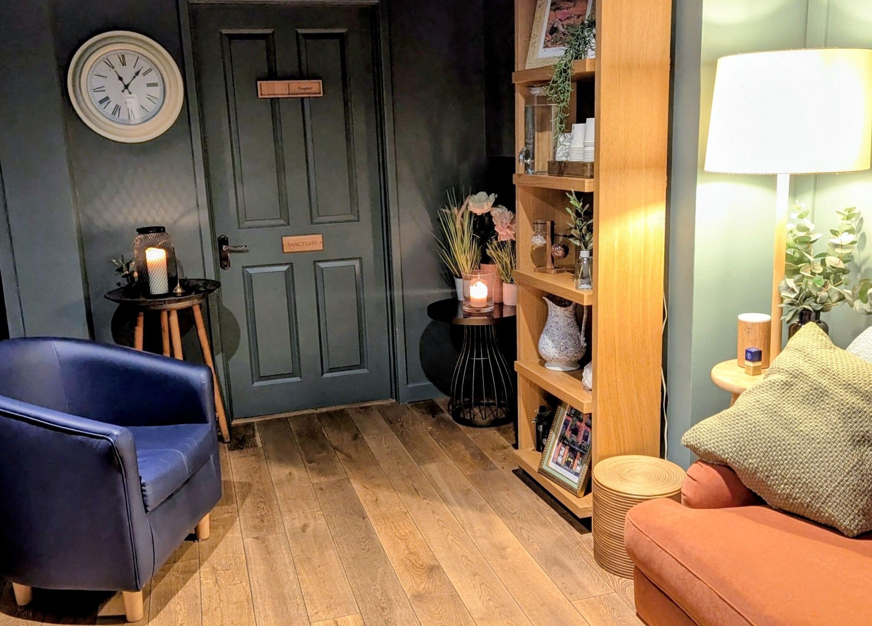 Inviting corner at Sanctuary & Sage, Cheltenham, England, GB. Warm lighting, plush seating, and decor.