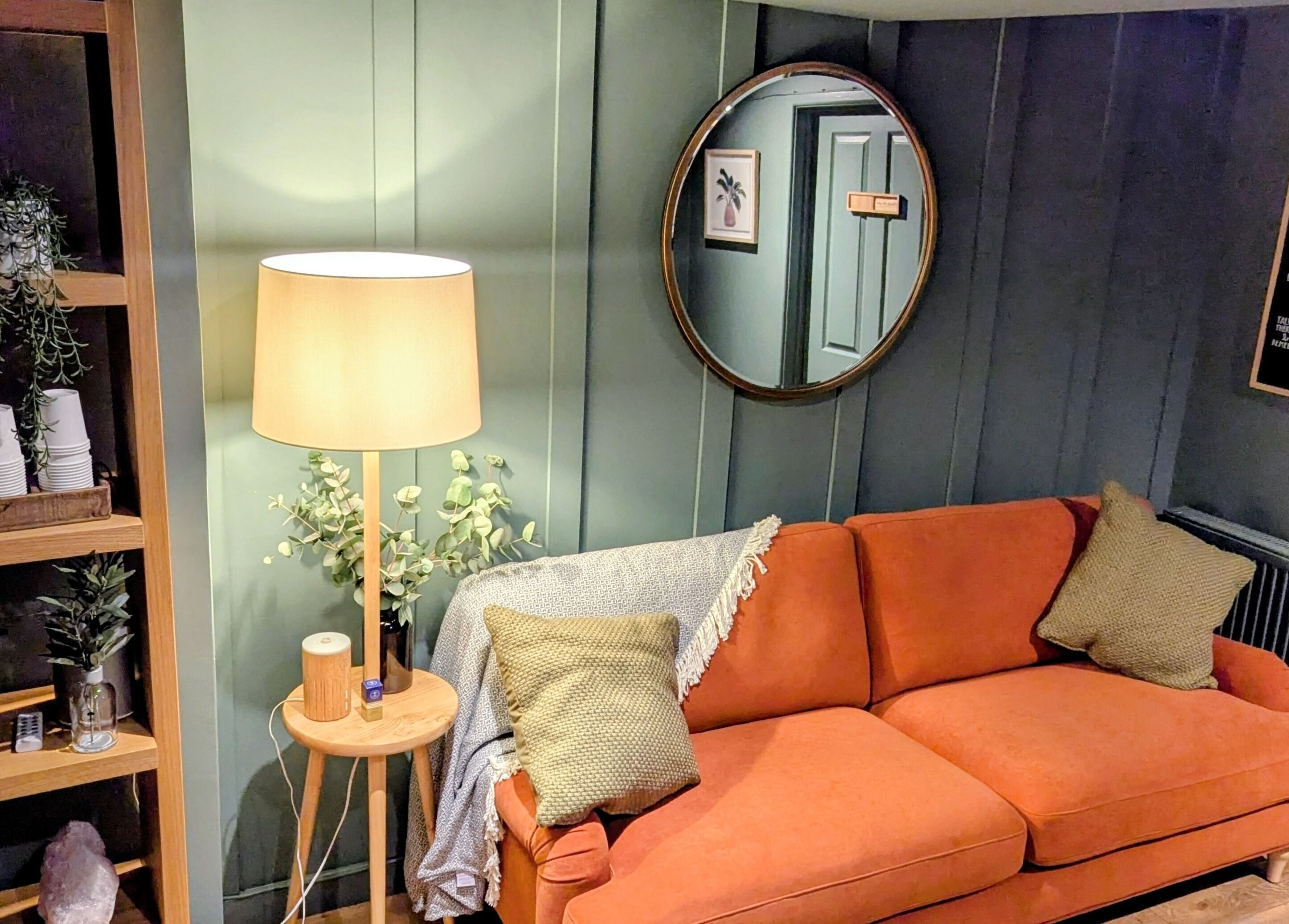 Inviting lounge area with orange sofa at Sanctuary & Sage, Cheltenham, England, GB.