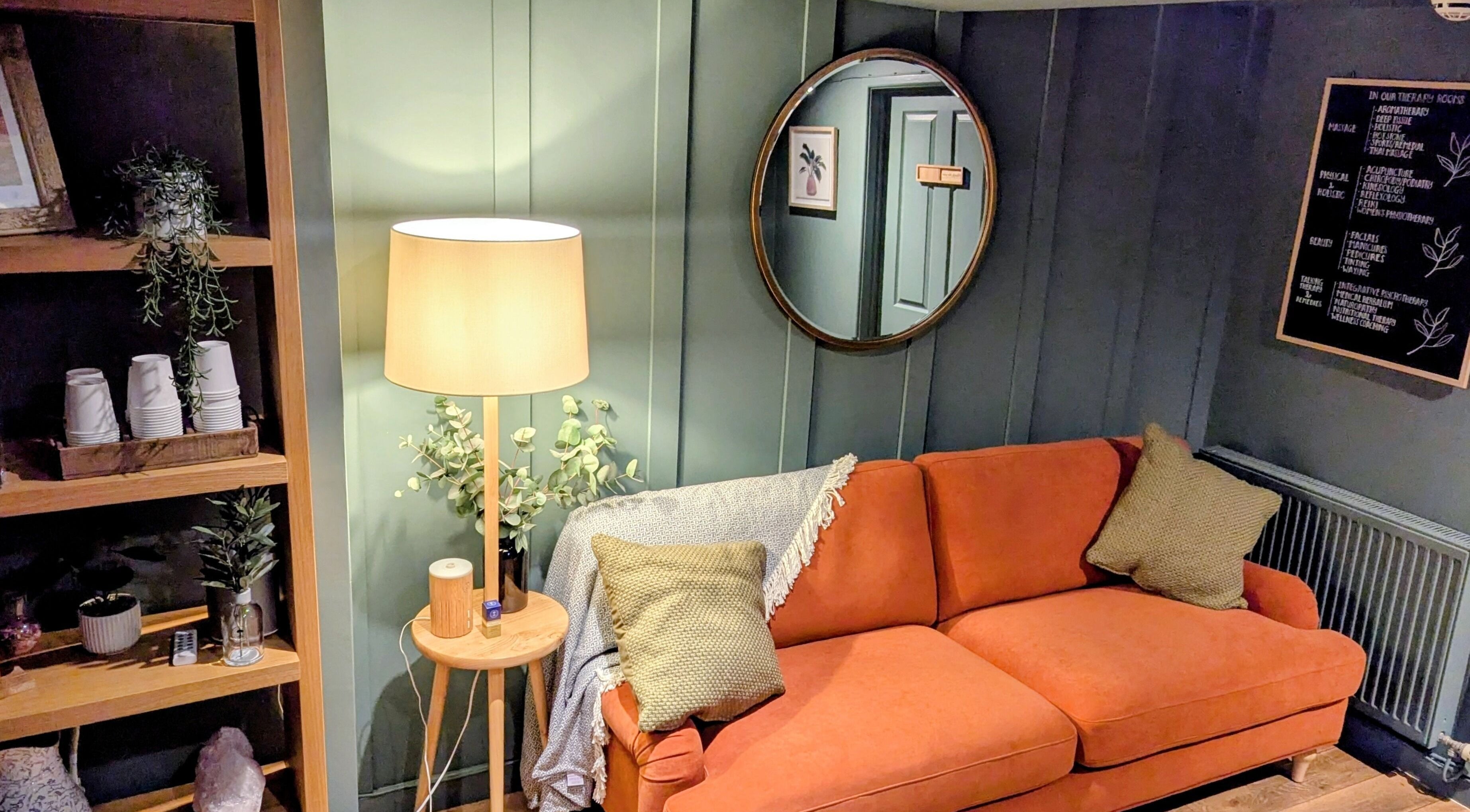 Inviting lounge area with orange sofa at Sanctuary & Sage, Cheltenham, England, GB.