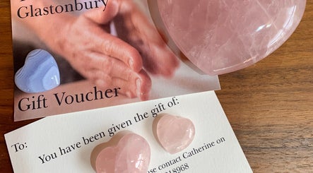 Gift vouchers and heart-shaped stones at The Massage Place, Glastonbury, England, GB, perfect for wellness gifts.