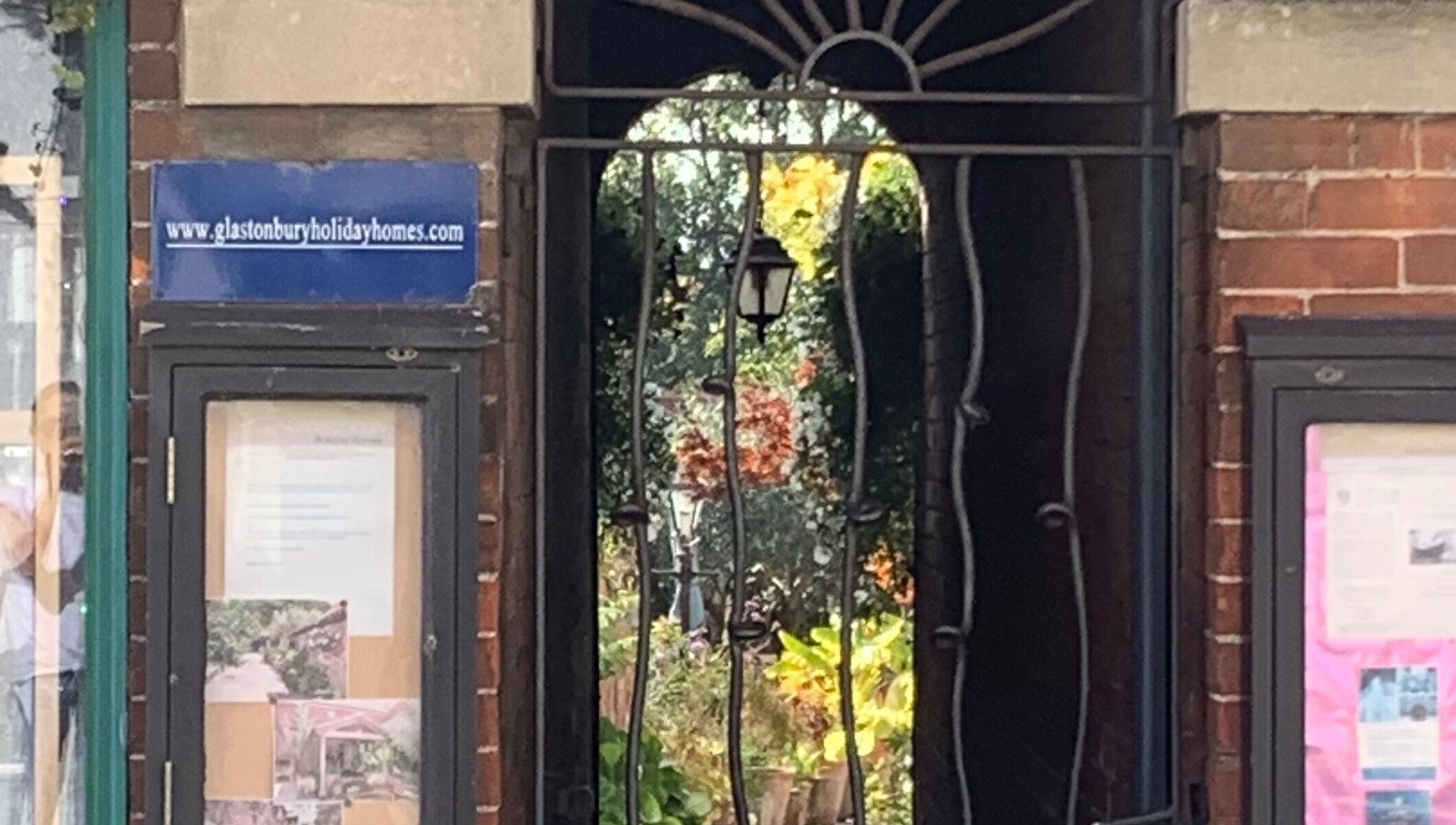 Charming garden entrance view at The Massage Place, Glastonbury, England, GB, hints at a tranquil experience.