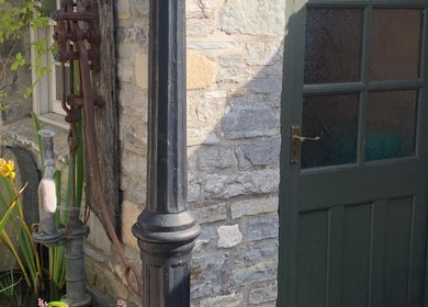 Charming rustic entrance at The Massage Place in Glastonbury, England, GB, featuring stone walls and greenery.