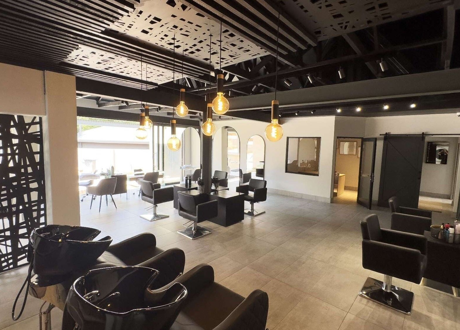 Modern interior of The Glow salon in Benoni, Gauteng, ZA with stylish chairs and ambient lighting.
