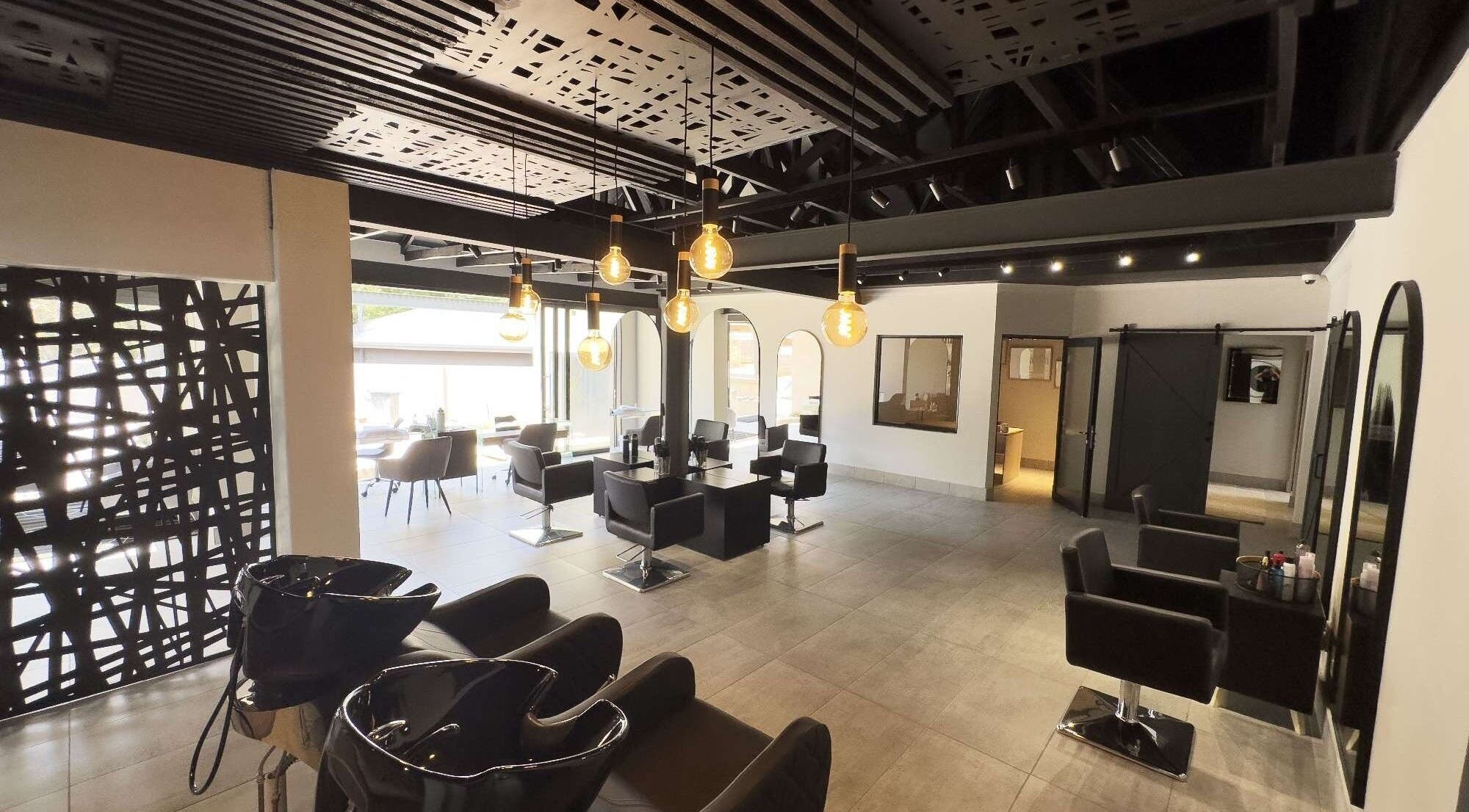 Modern interior of The Glow salon in Benoni, Gauteng, ZA with stylish chairs and ambient lighting.