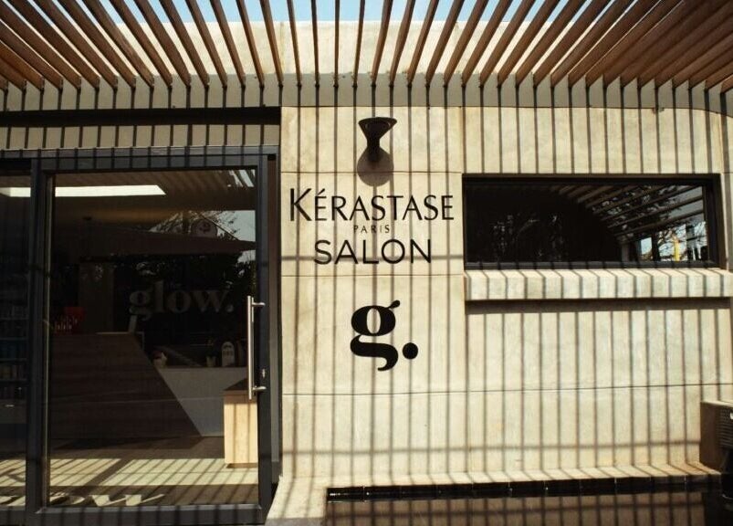 Exterior of The Glow salon in Benoni, Gauteng, ZA, featuring stylish wooden slats and modern design.