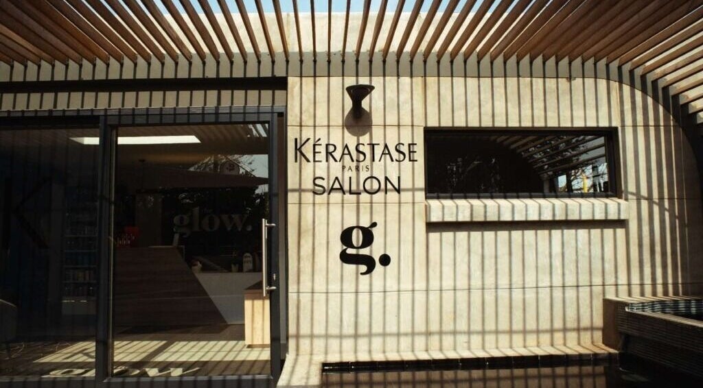 Exterior of The Glow salon in Benoni, Gauteng, ZA, featuring stylish wooden slats and modern design.