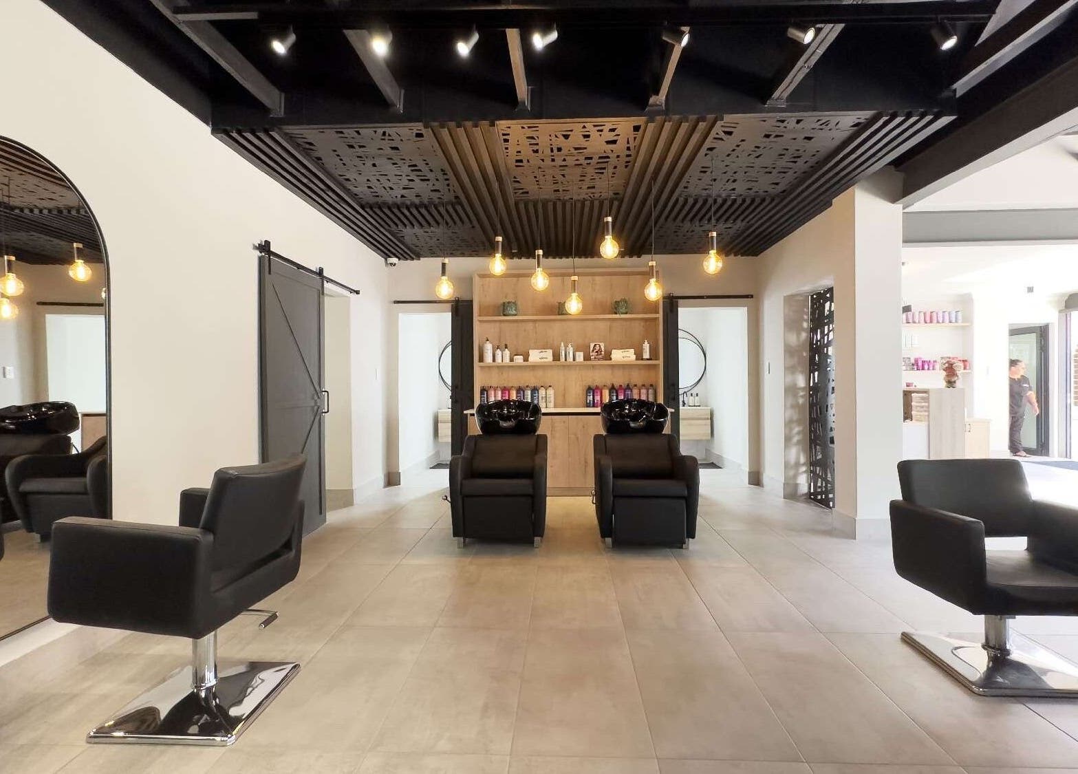 Elegant modern salon interior at The Glow in Benoni, Gauteng, ZA featuring stylish chairs and ambient lighting.