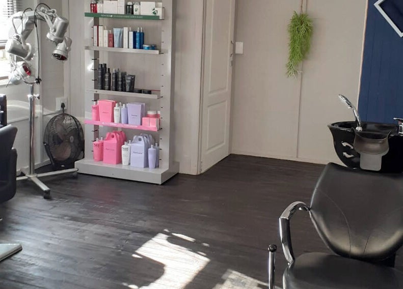 Modern salon interior at Studio M, Randburg, Gauteng, ZA, featuring sleek styling stations and premium products.