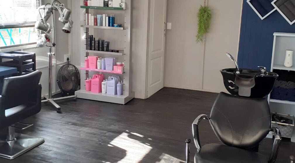 Modern salon interior at Studio M, Randburg, Gauteng, ZA, featuring sleek styling stations and premium products.