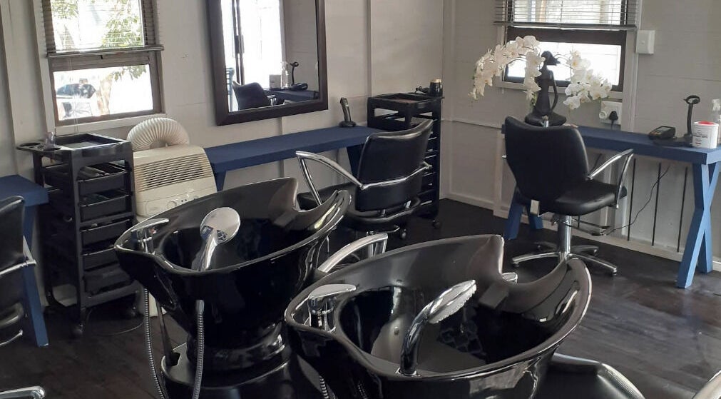 Modern salon interior at Studio M in Randburg, Gauteng, ZA with sleek hair-washing stations.