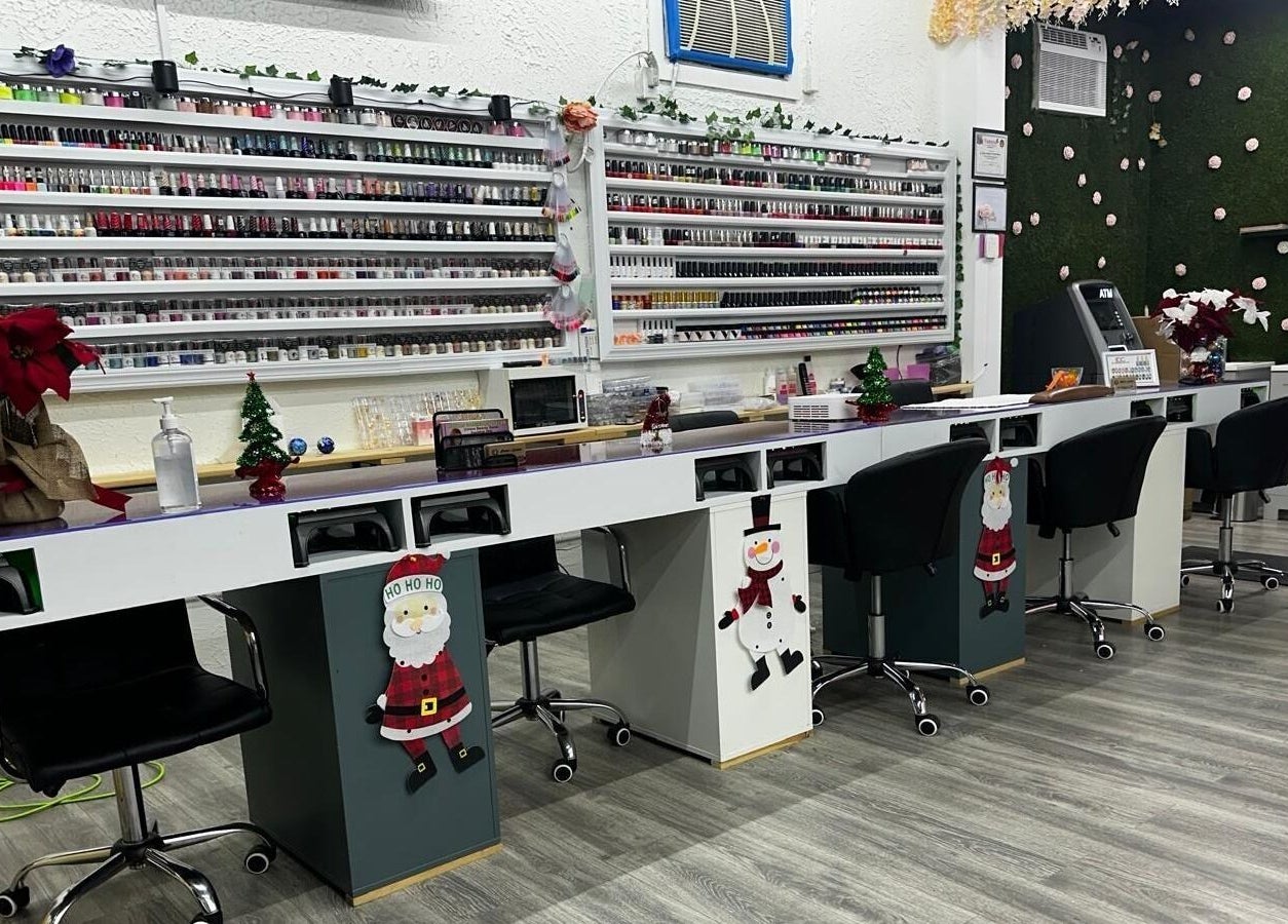 Chic nail stations at Alexa’s Dominican Salon in Woodbridge Township, New Jersey, US, featuring holiday decor and polish display.