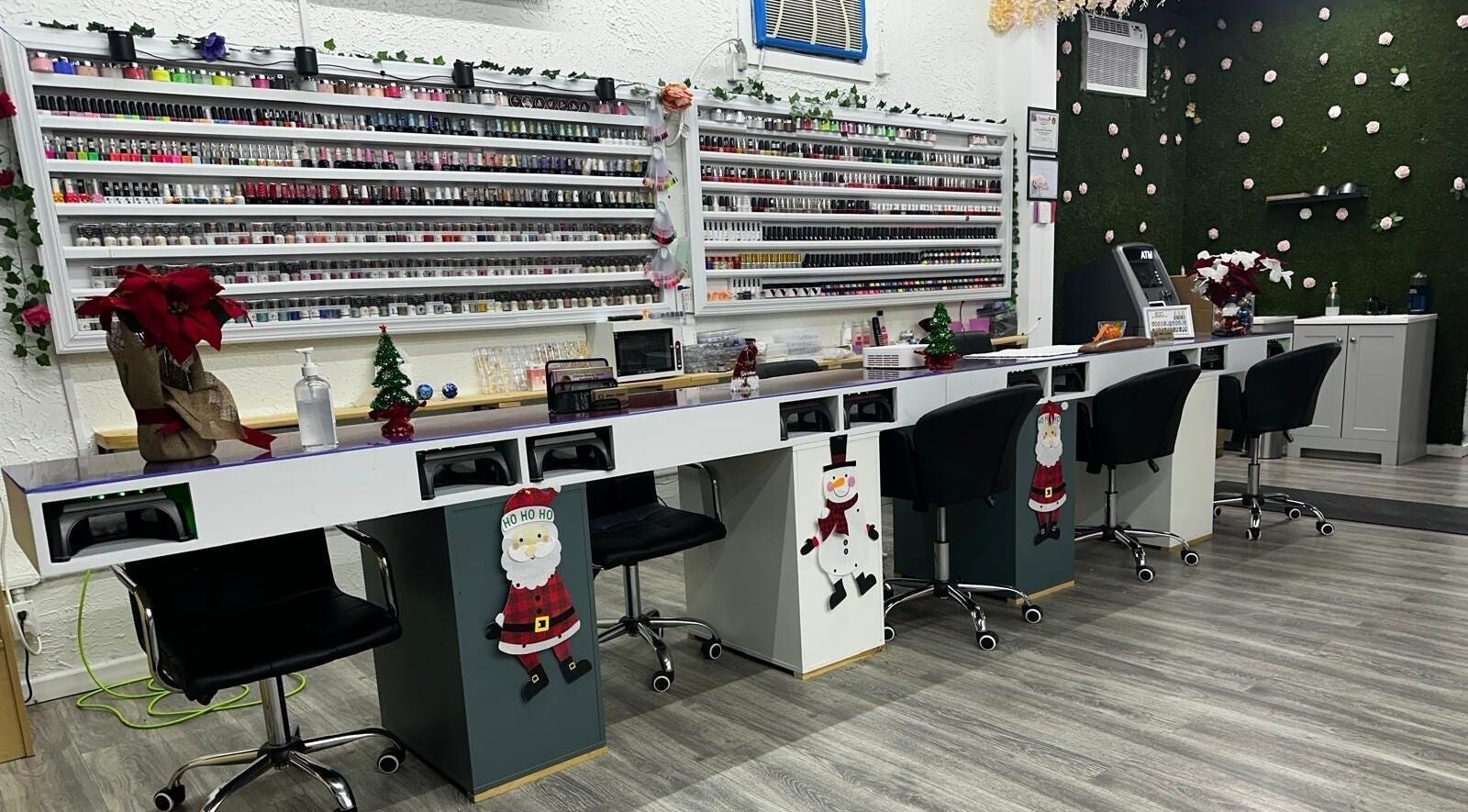 Chic nail stations at Alexa’s Dominican Salon in Woodbridge Township, New Jersey, US, featuring holiday decor and polish display.