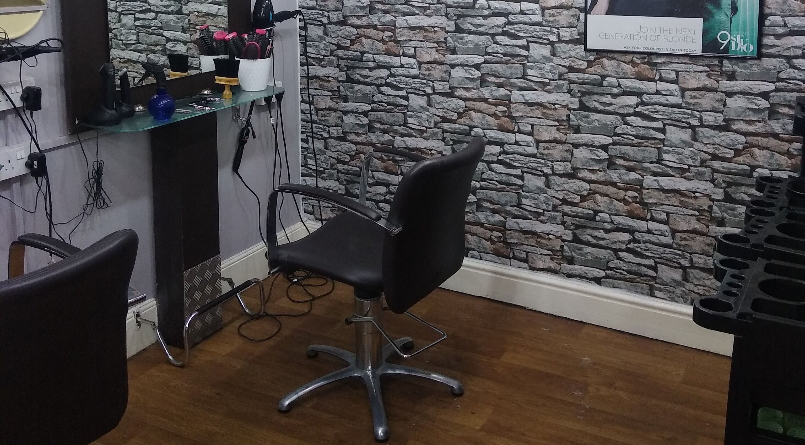 Modern salon chair and styling station at Neils Hairdressers Ltd, Needham Market, England, GB.