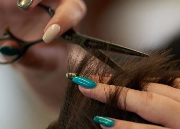 Expert hair trim at Dom Republic, Johannesburg, Gauteng, ZA. Precision scissors and styled nails in focus.