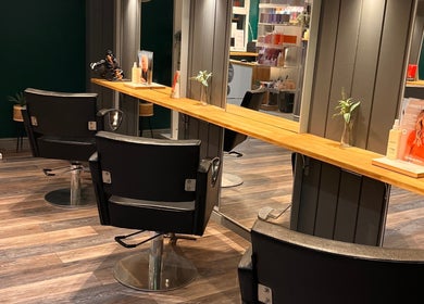 Modern salon chairs at Pearce and Chapman Hair and Beauty, Beddau, Wales, GB, inviting for a stylish makeover.
