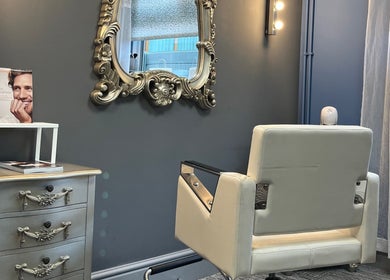 Elegant styling chair and ornate mirror at Pearce and Chapman Hair and Beauty in Beddau, Wales, GB.