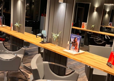 Modern salon setup at Pearce and Chapman Hair and Beauty, Beddau, Wales, GB with sleek chairs and styling stations.
