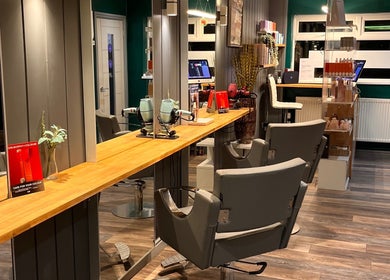 Modern salon at Pearce and Chapman Hair and Beauty, Beddau, Wales, GB with stylish chairs and mirrors.