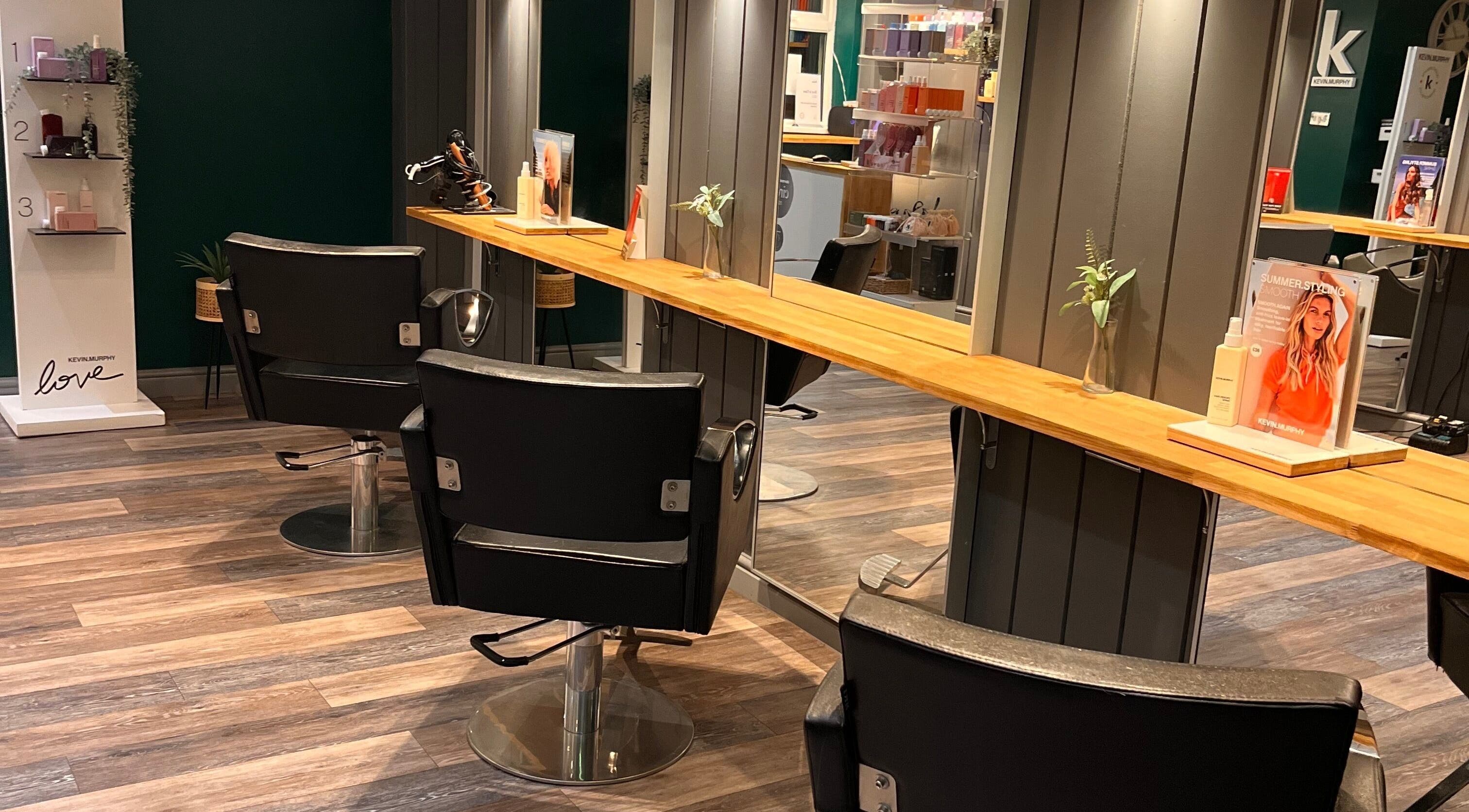 Sleek salon chairs at Pearce and Chapman Hair and Beauty, Beddau, Wales, GB with stylish decor.