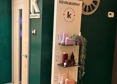 Interior at Pearce and Chapman Hair and Beauty in Beddau, Wales, GB, showcasing Kevin Murphy products on sleek shelves.