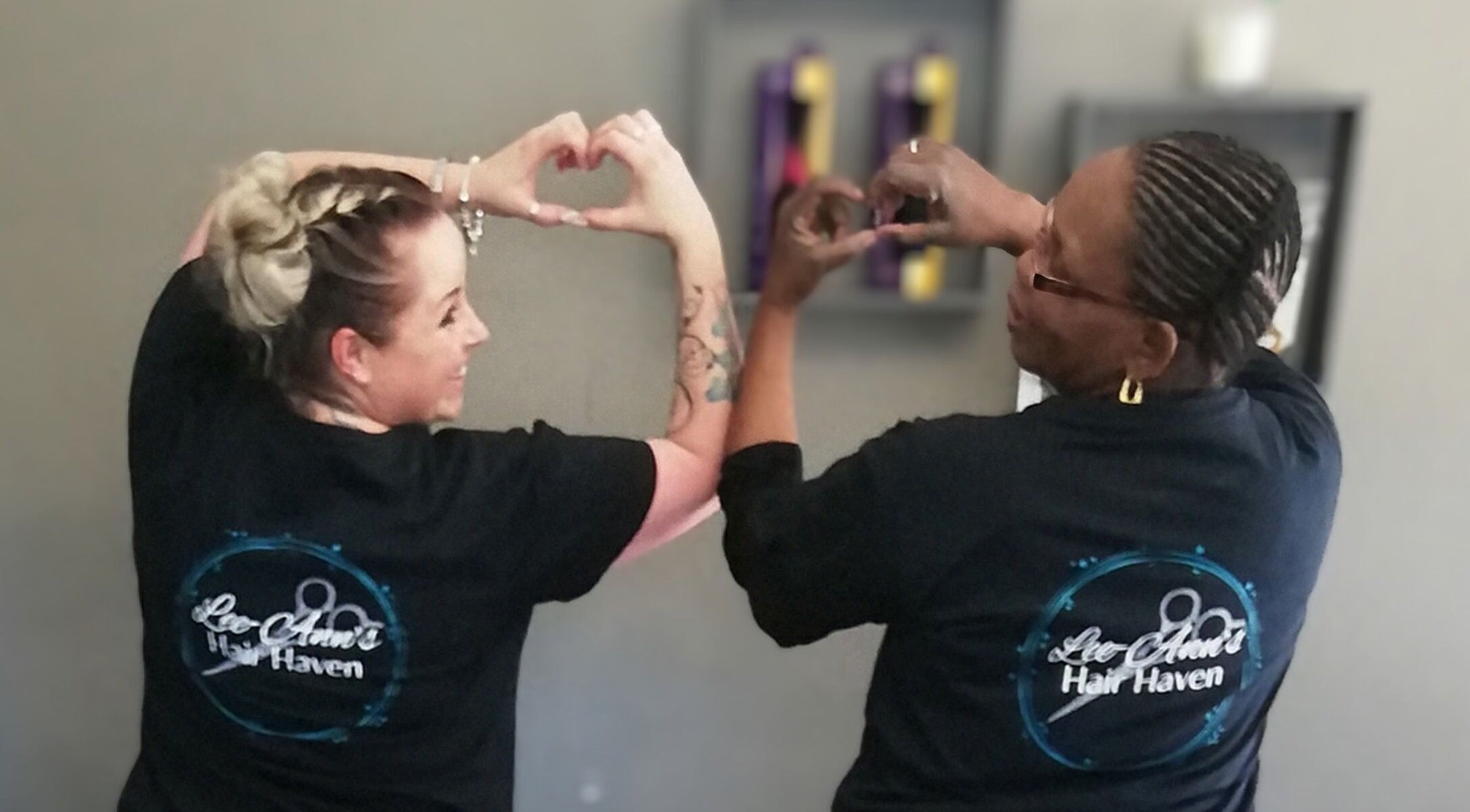 Stylists form heart symbols at Lee-Ann's Hair Haven, Randburg, Gauteng, ZA, showcasing salon unity.