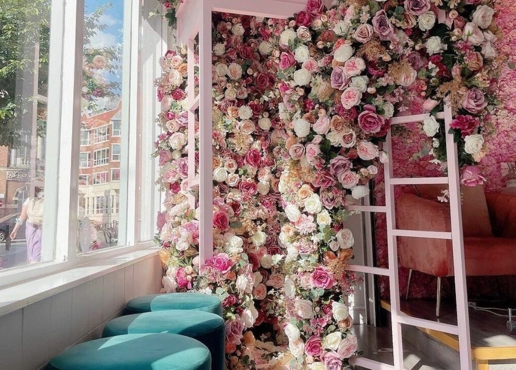 Elegant floral decor at Belle Ame Beauty Champagne Lounge, London, England, GB with natural light and cozy seating.