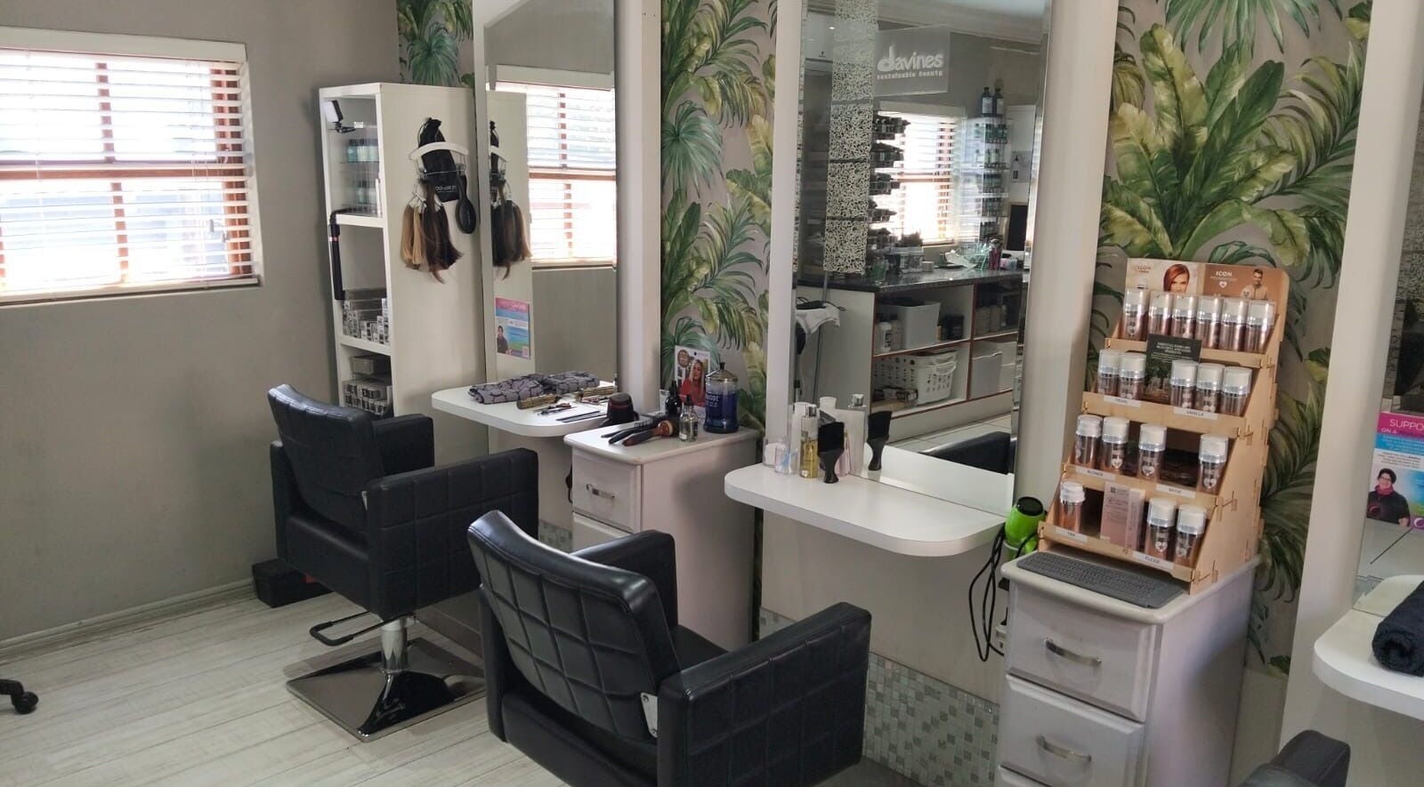 Modern styling area at Tanak Design / Hair by Nick Ashley, Pretoria, Gauteng, ZA featuring sleek chairs.