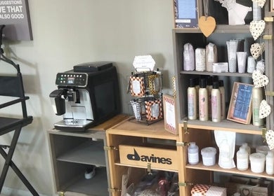 Cozy corner at Tanak Design / Hair by Nick Ashley in Pretoria, Gauteng, ZA, featuring products and a coffee station.