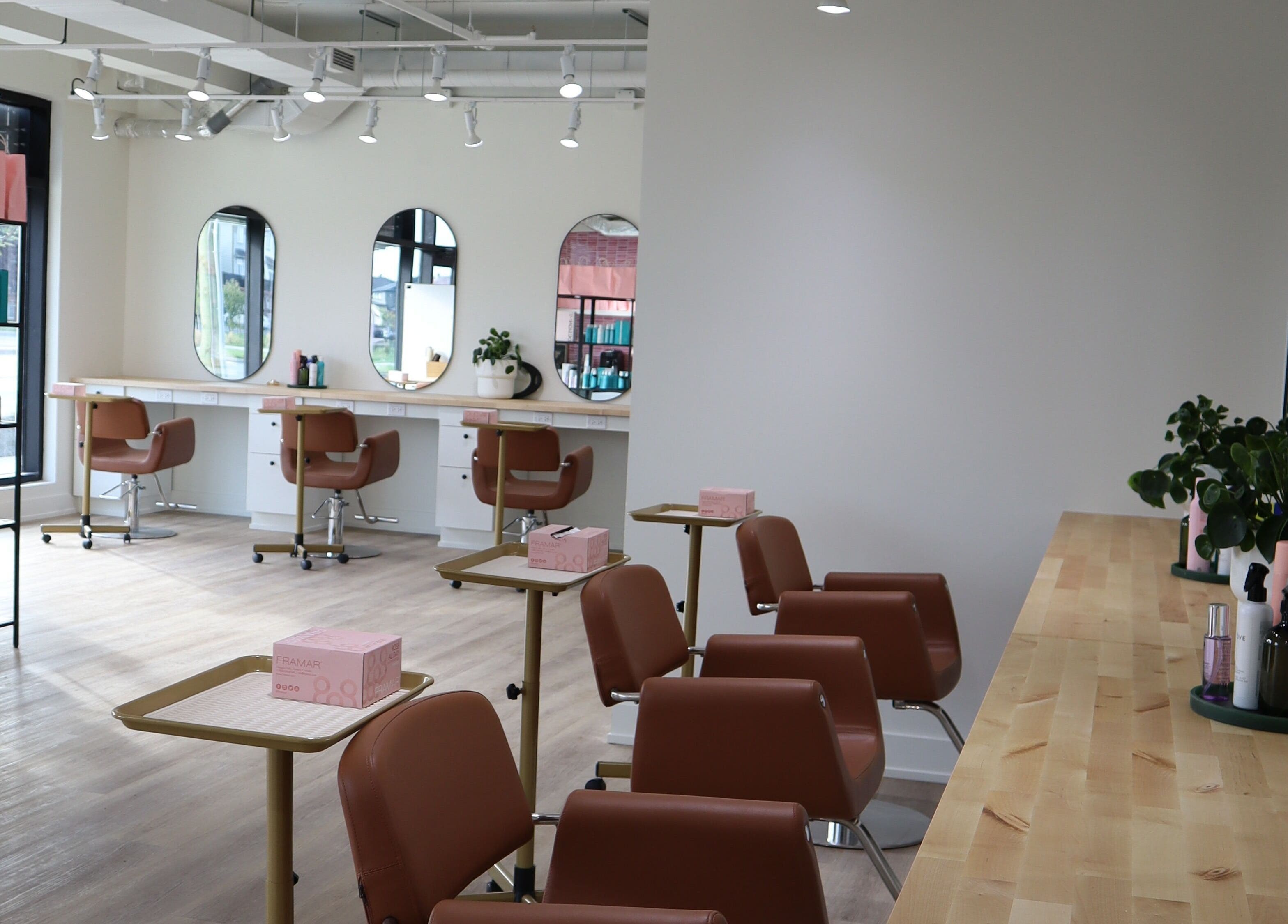 Spacious and stylish salon interior at Fika Beauty East, Ottawa, Ontario, CA, featuring chic decor and comfortable seating.