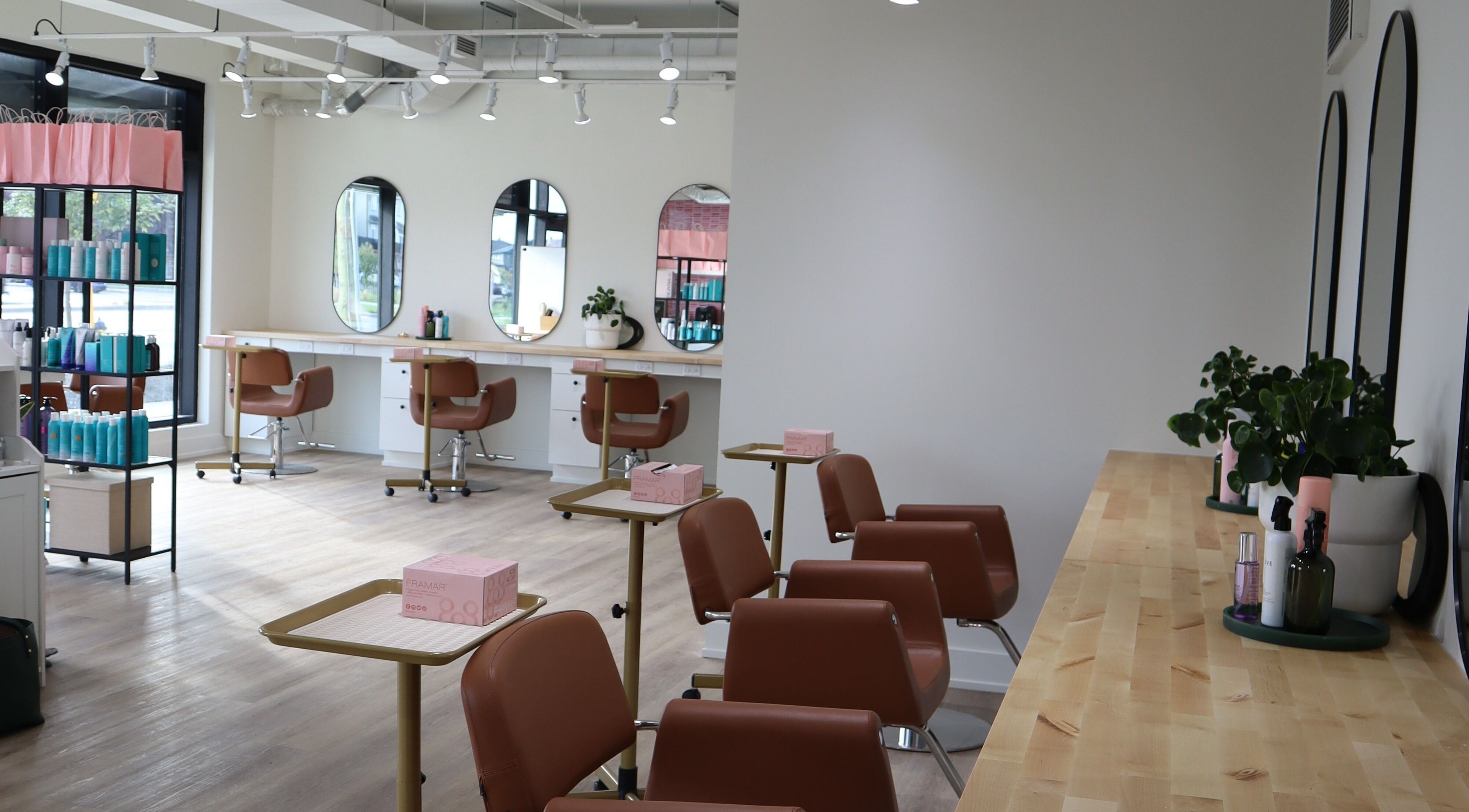 Spacious and stylish salon interior at Fika Beauty East, Ottawa, Ontario, CA, featuring chic decor and comfortable seating.