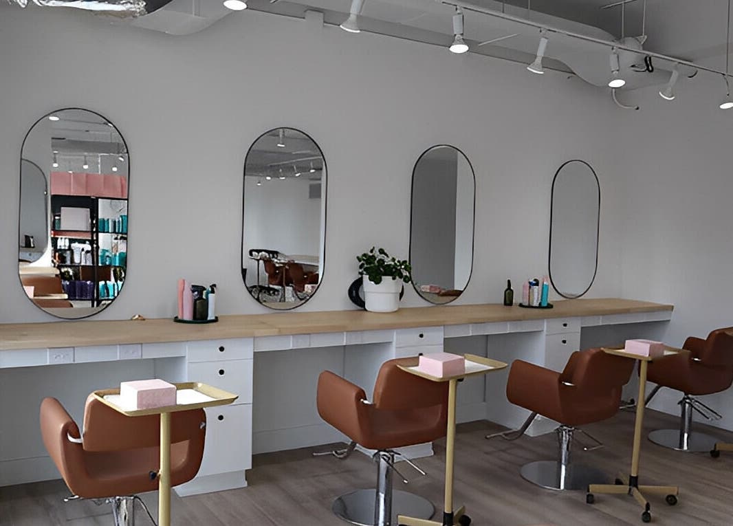 Modern salon interior at Fika Beauty East, Ottawa, Ontario, CA with stylish chairs and mirrors.