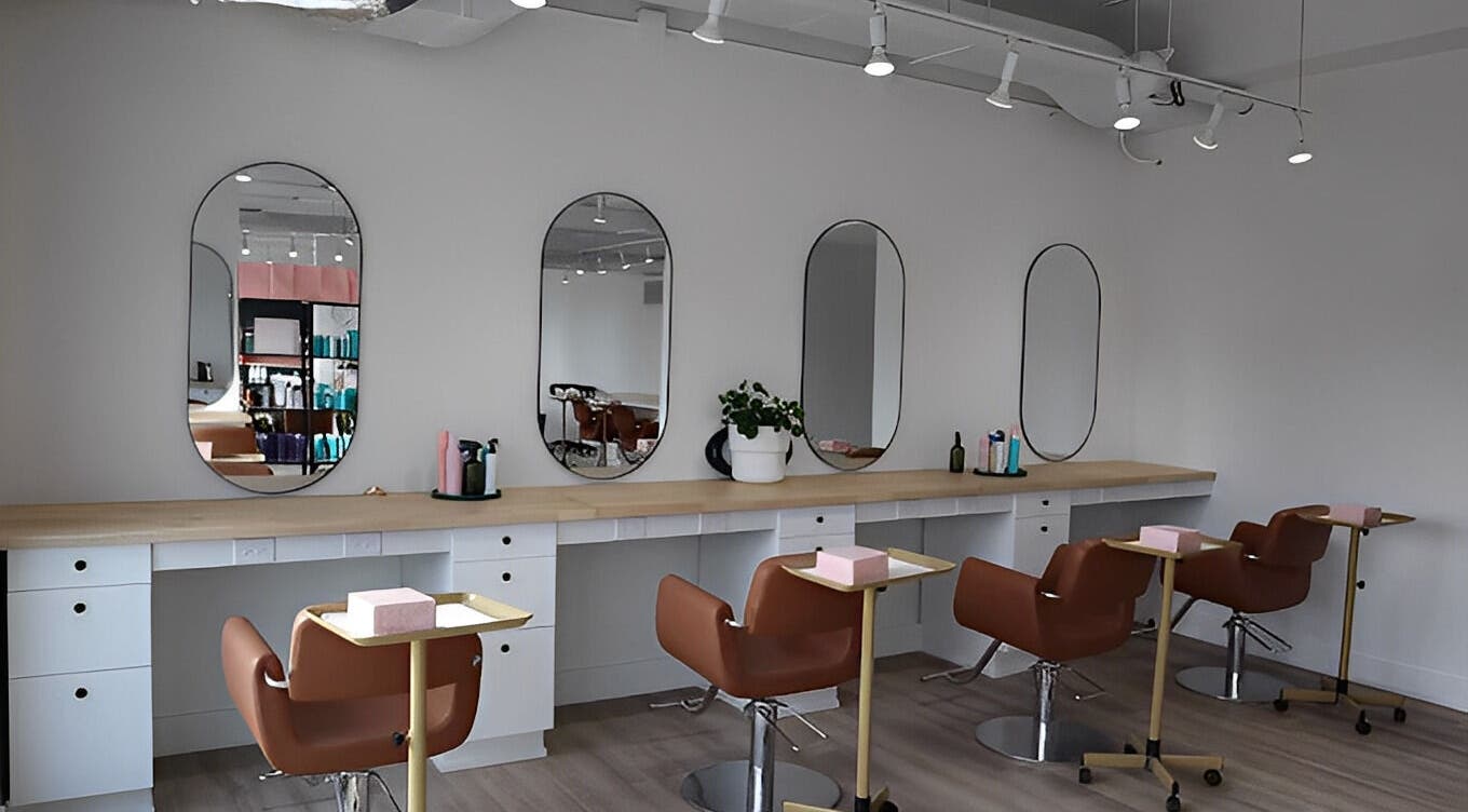 Modern salon interior at Fika Beauty East, Ottawa, Ontario, CA with stylish chairs and mirrors.