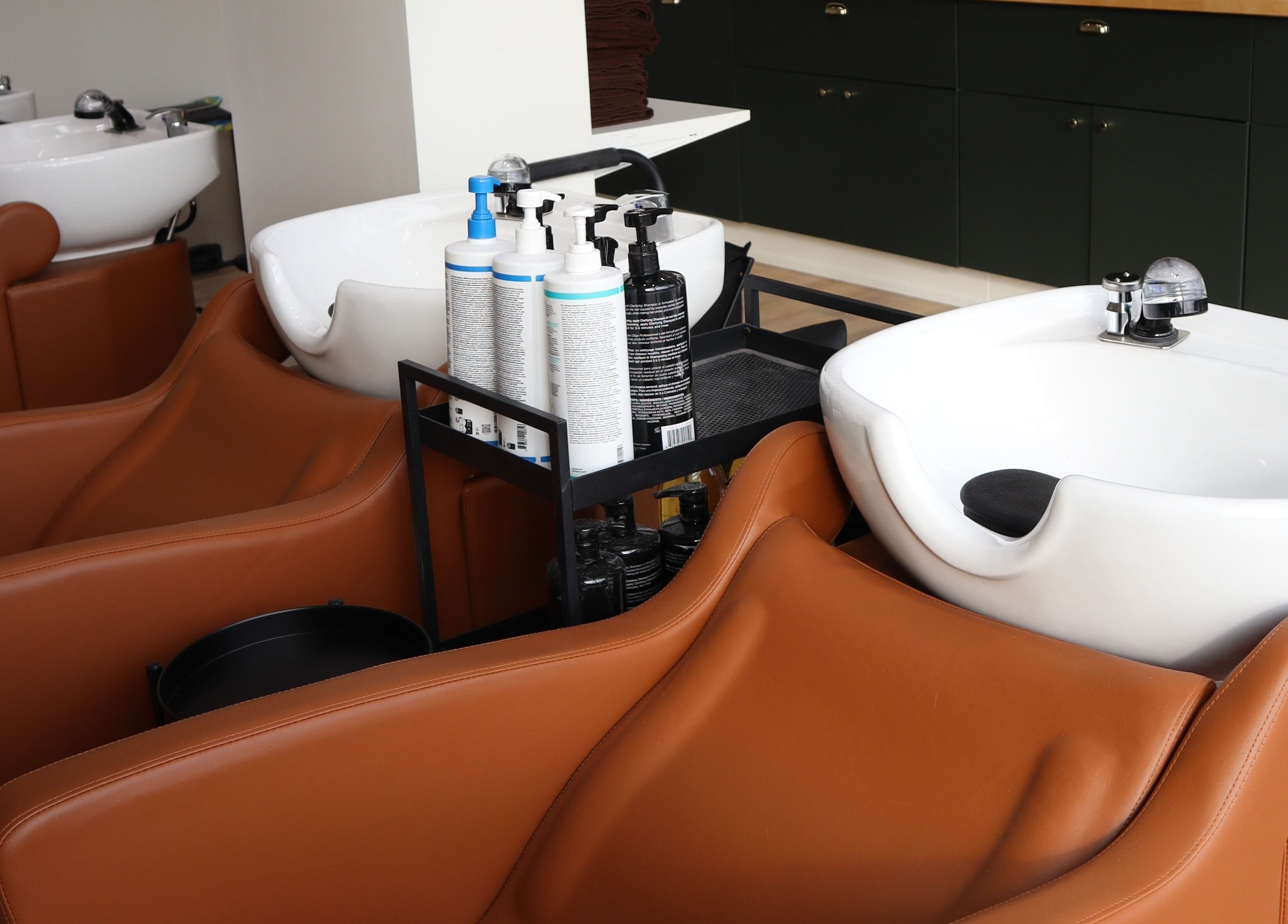 Elegant wash stations at Fika Beauty East, Ottawa, Ontario, CA, enhancing comfort and luxury.