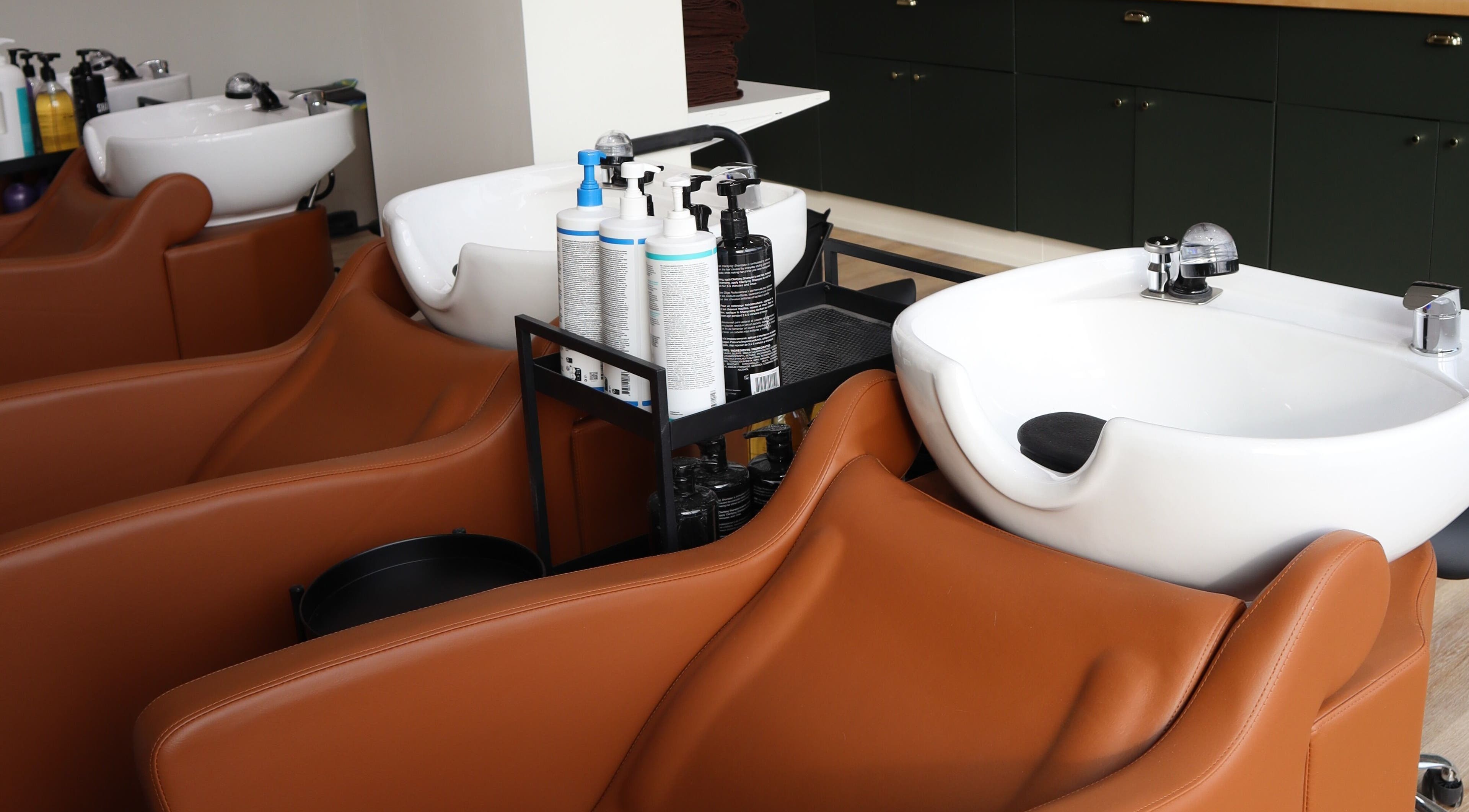 Elegant wash stations at Fika Beauty East, Ottawa, Ontario, CA, enhancing comfort and luxury.